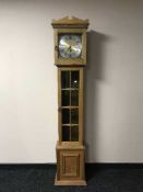 An oak long cased clock with pendulum and weights
