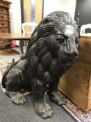An impressive pair of bronze seated lion figures