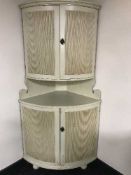 A cream double corner cabinet