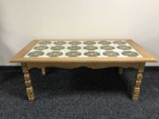 A blonde oak tiled topped coffee table