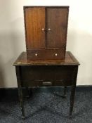 An oak sewing box with contents and a miniature cabinet