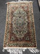 A Kashmir silk piled fringed rug