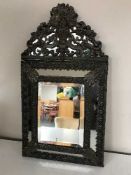 A metal framed cushion mirror