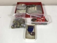 A box of various military badges and buttons,