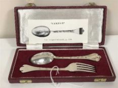 A cased pair of silver spoons and matching silver fork,