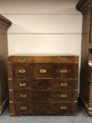 A mahogany campaign-style chest of six drawers around a central drawer, with brass fittings,