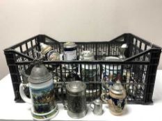 A basket of pewter lidded tankards, ash trays,