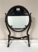 A late Victorian mahogany toilet mirror and a brass table lamp