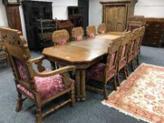 An impressive thirteen-piece Continental carved oak dining room suite comprising an extending