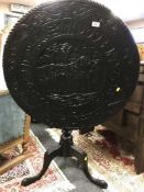 A Georgian carved oak circular tilt-topped table, on a tripod base, width 80 cm.