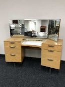 A teak knee hole dressing table and mirror