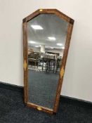 An inlaid mahogany coffin shaped mirror