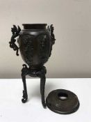 A Japanese Meiji period bronze urn on tripod base, height 25 cm,