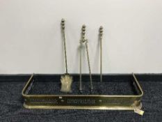 An early 20th century brass fire curb and companion set