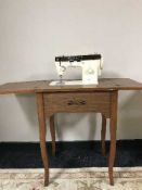 A Singer electric sewing machine in table