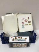 A basket of stamp albums and loose stamps