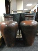 A pair of large terracotta lidded urns