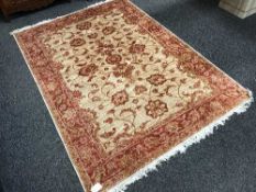 A fringed Persian Ziegler rug, on red ground, 230 cm x 160 cm.