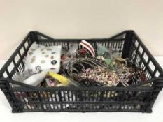 A box of assorted costume jewellery, pin badges,