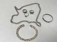 A silver curb chain, three rings,