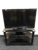 A Panasonic 32 inch LCD TV with DVD player on stand