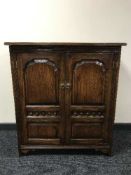 A reproduction oak audio cabinet