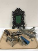 An ornate cherub frame, plated spoons,