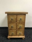 A contemporary hard wood six drawer chest