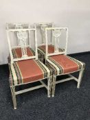 A set of four cream and gilt dining chairs