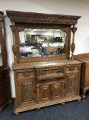 A Victorian carved oak mirror backed break-front sideboard