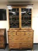 A George III style inlaid mahogany bookcase,
