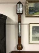 A 19th Century walnut stick barometer.
