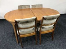 A pull out teak table and four chairs