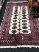 A fringed woollen Bokhara rug cream ground