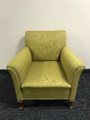 An armchair upholstered in green fabric