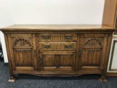 A Victorian heavily carved oak sideboard
