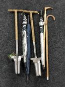 A horse measuring cane, three oversized umbrellas,