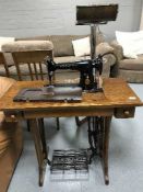A Singer treadle sewing machine in oak table