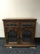 A hardwood display cabinet with metal handles and fittings