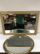 A gilt framed mirror and an oval mirror