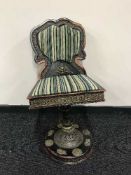 An ebonised Tibetan swivel chair with metal decoration