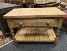 A reclaimed pine butcher's block, fitted with a drawer, with undershelf, width 111 cm.