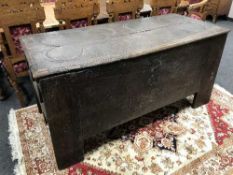 A Continental 18th Century carved oak coffer, width 166 cm.