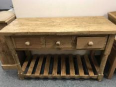 A reclaimed pine table fitted with three drawers, width 135 cm.