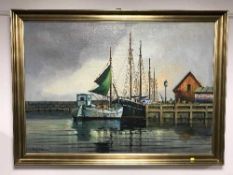 A gilt framed oil on canvas depicting fishing boats,