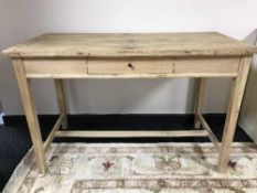 A stripped pine kitchen table fitted a drawer