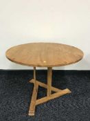 A circular pine pedestal coffee table and lamp table