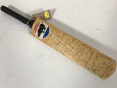 A miniature Symonds Cricket bat signed by the Lord Tabeners