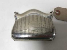 A silver purse bearing Birmingham hall marks