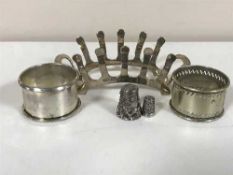 A silver toast rack, silver napkin ring,